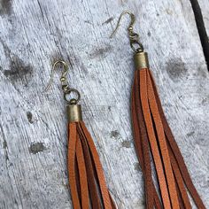 "-These boho tassel earrings are made from soft rust-color deerskin leather. Part Cowgirl, part Rock & Roll, the tassel earrings give a big kick to any outfit. -Dramatic but lightweight enough to wear every day. -9\" total length. -Earwires are antique-brass. Goldfill earwires are available by request. -Deerskin leather is sustainably sourced in the USA. -Ok to get wet. -Available in 14 colors. -Designed and handmade in South Pasadena, CA. Check out more of our lovely earrings here: https:// Bohemian Brown Beaded Tassel Earrings, Brown Tassel Earrings For Festivals, Brown Fringe Tassel Earrings For Festivals, Handmade Brown Tassel Earrings, Brown Dangle Tassel Earrings With Fringe, Brown Fringe Dangle Tassel Earrings, Brown Fringe Tassel Dangle Earrings, Adjustable Brown Bohemian Tassel Earrings, Brown Dangle Earrings With Tassels