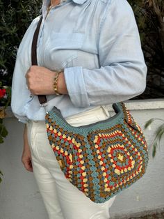 "Discover the perfect blend of style and functionality with our hand-knit granny square motif bag, ideal for everyday use. Crafted with cotton yarn, its vibrant colors and intricate motifs make it a standout accessory.  The bag features an adjustable strap and a secure zipper closure, ensuring your essentials like phone, wallet, and keys are always within reach. Inside, a soft lining adds a touch of luxury. Whether you're heading out for shopping or a leisurely stroll, this versatile Fanny bag offers exceptional comfort and ease. Wear it as a crossbody bag for added convenience. Available in a variety of colors, choose the one that suits your style best and enjoy this cute, practical bag for daily adventures. All items are shipped with express delivery, which typically takes 2-3 days for E Bohemian Hand Knitted Bags For Everyday Use, Casual Shoulder Bag With Granny Square For Everyday Use, Handmade Casual Hobo Bag For Festivals, Casual Granny Square Shoulder Bag For Everyday Use, Casual Handmade Hobo Bag For Festivals, Bohemian Granny Square Bags For Everyday, Casual Crochet Bag With Granny Square For Daily Use, Trendy Granny Square Shoulder Bag For Everyday, Casual Hand Knitted Rectangular Shoulder Bag