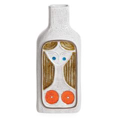 a bottle shaped like a woman with oranges in her hair and eyes on it