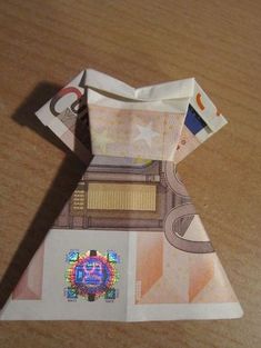 an origami piece of paper with money on it