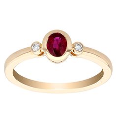 a gold ring with a red stone and two diamonds