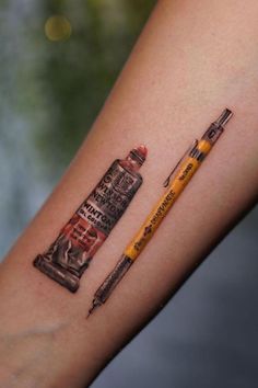 a pencil and some type of tattoo on the arm