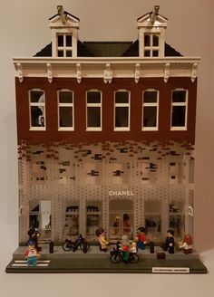 a lego model of a building with people on bikes