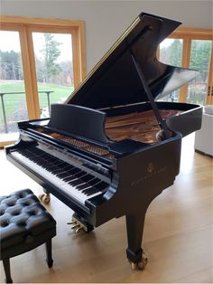 a grand piano sitting in the middle of a living room