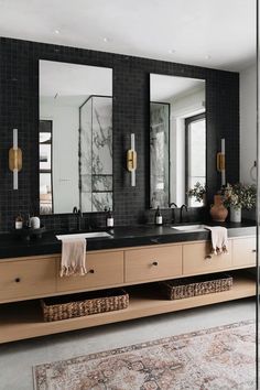 a bathroom with two sinks and mirrors in it