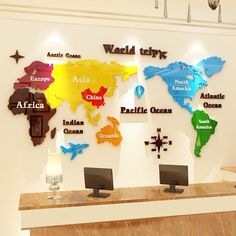 a reception desk with several different colored world maps on the wall