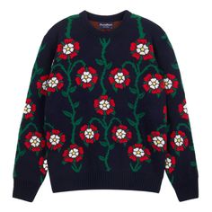 a blue sweater with red and white flowers on the front, and green trim around the neck