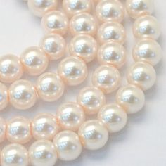 a strand of white pearls on a white background