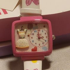 This Mini Brand Handcrafted Watch Is A Unique Timepiece That Features A Fashion Theme. The Hand Created And Hand Painted Decorations On The Front Of The Watch Includes A Creme-Colored Dress With Blue Dots And Yellow Scallops On The Collar And Hemline & A Black Belt With Gold Buckle And A Red Heart. Also Featured Are Three Red Crystals As Accents. The Watch Has A Square Shape And A Wide White Band Made Of Faux-Leather With Hearts And Dots On Both The Bottom Band And On The Top Band. The Face Feat Sherly Temple, Cutecore Clothes, Weird Watch, Vintage Gold Watch, Belt With Gold Buckle, Silly Gifts, Mini Accessories, Hand Painted Decor, Blue Dots