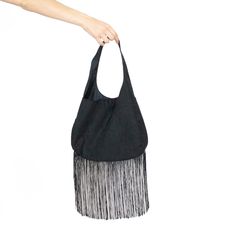 "Black suede shoulder bag with large fringe detail. The sleek one strap design of this handbag is very simple and elegant while the maxi fringe gives this medium size bag a fun boho detail.  Very soft to the touch with a playful vibe, this bag is the one to replace your old basic black purse! Measurements: 18.5\" from strap top to bottom edge Body: 10\" by 13\" Fringe: 9\" - Fully lined - Magnetic closure - Polyester blend faux suede - Delicate wash and dry More FashionMeme https://www.etsy.com/ Chic Travel Hobo Bag With Fringe, Chic Fringe Hobo Bag For Travel, Chic Travel Bucket Bag With Fringe, Chic Travel Shoulder Bag With Fringe, Chic Fringe Shoulder Bag For Travel, Chic Tote Shoulder Bag With Tassels, Chic Tassel Tote Shoulder Bag, Chic Crossbody Hobo Bag With Fringe, Chic Fringed Crossbody Hobo Bag