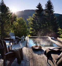 a wooden deck with two chairs and a bowl of fruit on the table next to it