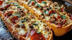 a close up of a pizza on a pan with cheese and toppings in it