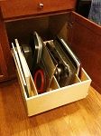 an open drawer with scissors and other tools in it