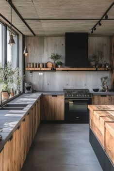 a kitchen with wooden cabinets and counter tops next to a window that has potted plants on it