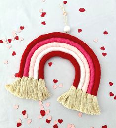 a red and white rainbow ornament surrounded by confetti