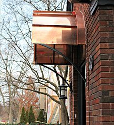 a lamp on the side of a brick building