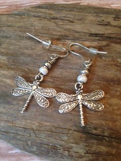 These gorgeous Boho Style Dragonfly Earrings are perfect for your summer wardrobe! So pretty with colors of cream and silver made with cream Czech seed beads, silver Tibetan beads and beautiful, detailed Silver Dragonfly charms! * I can switch out the cream beads for any color-just ask and I will be happy to do so.* The earring wires are lead free and will come with rubber backs. Beautiful gift idea which will come on a pretty gift box and organza bag! I have the complete jewelry set available f Bohemian Adjustable Butterfly Earrings, Bohemian Silver Butterfly Earrings, Bohemian Style Jewelry, Dragonfly Jewelry, Earring Wires, Dragonfly Earrings, Funky Jewelry, Jewelry Lookbook, Bohemian Earrings