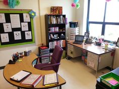 a classroom with desks, chairs and bookshelves in front of large windows