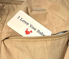 a label that says i love you babe on the pocket of a bag with two hearts