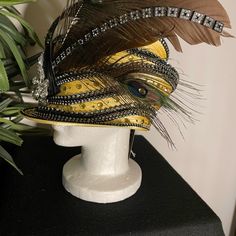 Donna Vinci Couture Yellow Embellished Hat With Feathers New With Tag One Size Fits Most Has An Adjustable Band For Sizing 100% Polyester See Photos For Details Please Note Missing Feathers In Photos 6 And 10 Traditional Carnival Costume Hats And Headpieces For Party, Designer Curved Brim Hats For Parties, Traditional High Crown Headpiece For Party, Elegant Fitted Carnival Headpiece, Kentucky Derby Party Hat Embellished, Kentucky Derby Party Embellished Hat, Embellished High Crown Hats For Party, Elegant Costume Hats And Headpieces For Mardi Gras Party, Party Hats With Bead Caps