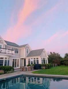 a large house with a pool in front of it