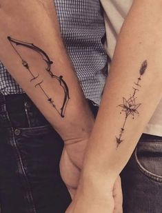 two people holding hands with tattoos on their arms and the words unique couple tattoos for all the lovers out there