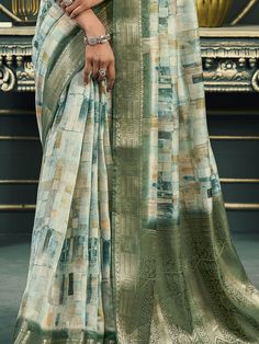 Introducing our exquisite off-white and green cotton saree, a harmonious blend of traditional elegance and modern sophistication. This saree is meticulously crafted with intricate digital printwork that adds a contemporary flair to its classic design. The rich weaving pallu and the intricately designed weaving border enhance its regal appearance, making it a timeless piece suitable for any occasion. The soft cotton fabric ensures maximum comfort, allowing you to drape it effortlessly and elegant Green Pre-draped Saree With Printed Motifs For Diwali, Unstitched Digital Print Saree For Eid, Traditional Green Pre-draped Saree With Printed Motifs, Traditional Saree With Digital Print For Eid, Traditional Saree For Eid With Digital Print, Green Chanderi Dupatta With Digital Print, Green Semi-stitched Dupatta With Digital Print, Green Cotton Dupatta With Digital Print, Green Digital Print Saree With Motifs