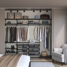 an organized bedroom closet with clothes hanging on the rails and shoes in baskets, along with a chair