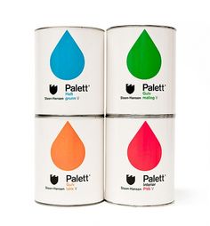 four cans of paint with different colors on them