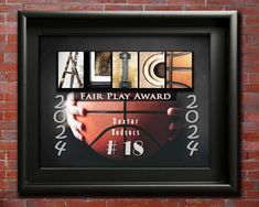 a black frame with the words, air play award and basketball on it in front of a brick wall