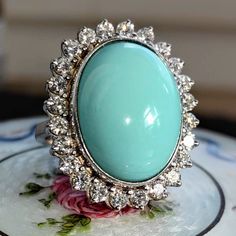 Size: 5 US 49 EU (FREE RESIZING) Metal Type: 18k white gold Weight: 16.6 grams Diamonds weight: 1.20 ct. Color:H Clarity: VSI Natural turquoise: 15mm x 19mm Condition: excellent  Introducing our Vintage 1960s sky blue turquoise and 1.20 ct. Diamond 18k Solid White Gold Statement Ring- a perfect blend of vintage charm and modern elegance. This ring is meticulously crafted from 18k solid white gold, ensuring a timeless appeal and lasting durability. The ring features a beautiful soft blue turquois Luxury Vintage Blue Turquoise Ring, Oval Turquoise Ring With Diamond Accents, Oval Turquoise Ring With Diamond Accents For Anniversary, Formal Oval Turquoise Ring With Diamond, Oval Diamond Turquoise Ring For Formal Occasions, Turquoise Oval Jewelry With Halo Setting, Oval Turquoise Ring With Center Stone For Anniversary, Oval Turquoise Jewelry With Halo Setting, Luxury Silver Turquoise Ring With Oval Shape