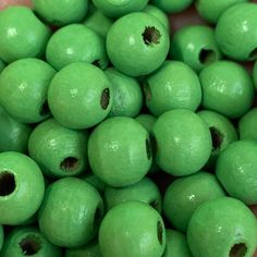 green beads are being held in a person's hand