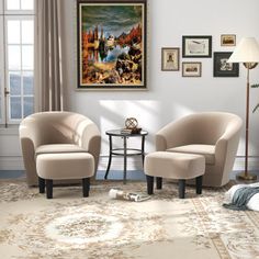 a living room with two chairs and a table in front of a painting on the wall