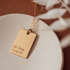 A unique way to personalize your pendant and make a statement! Our Luna rectangle necklace is 1/2" x 3/4". Pendant can fit up to 4 lines of texts and 6 letters for each line. Or one line of text and symbol (rainbow, mountain, bloom flowers, monstera leaf, succulent, baby footprints or sunshine) •D E T A I L S• -Available in 14k gold filled + sterling silver -Chain length 16", 18", 20", 24" -Cable chain and spring clasp included GIVING THIS AS A GIFT? Your jewelry will arrive to you in one of our Meaningful Everyday Rectangular Jewelry, Meaningful Gift Necklace, Meaningful Rectangular Necklaces For Gifts, Meaningful Rectangular Necklace For Gift, Meaningful Rectangular Jewelry For Everyday Use, Minimalist Customizable Rectangular Necklaces, Minimalist Customizable Rectangular Necklace, Spiritual Personalized Rectangular Jewelry, Customizable Rectangular Minimalist Necklace