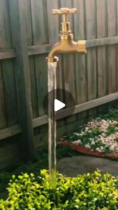 a water faucet in the middle of a garden