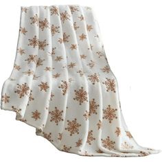 a white and gold blanket with snowflakes on the bottom, in front of a white background