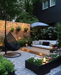 an outdoor living area with lots of plants and lights