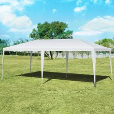 a white tent sitting on top of a lush green field