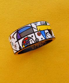 Art Bangle from wood handmade White Red Blue Black Yellow acrylic painting inspired by Joan Miro works Jewelry Gift #HandPaintedBangle #JoanMiro #ArtBangle #PaintedBangle #MediumSizeBangle #HandmadePainting #WoodenBangle #LadiesGift #MadeInGreece #HandmadeBangle Artistic Black Bracelets For Gifts, Artistic Black Bracelet As A Gift, Artistic Black Bracelet For Gift, Artistic Black Bracelets As A Gift, Unique Hand Painted Multicolor Bracelets, Hand Painted Wearable Art Bracelet As Gift, Artistic Hand-painted Bracelets As Gifts, Artistic Hand Painted Bracelets As Gift, Hand Painted Enamel Bracelets As Gift