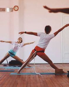 three people are doing yoga in a room