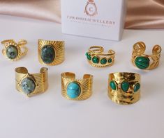 Elevate your style with our exclusive collection of gold textured rings, each set with a stunning natural gemstone. These unique, adjustable rings blend intricate textures with the natural beauty of turquoise, malachite, and other gemstones, offering a chic and sophisticated look for any occasion.   Distinctive Textures: Each ring features unique patterns, enhancing the overall design and appeal.   Natural Gemstones: Carefully selected turquoise, malachite, and other gems provide a vibrant splas Adjustable Gold Turquoise Gemstone Ring, Elegant Adjustable Gold Turquoise Ring, Bohemian Gold Rings With Stones, Unique Gold Emerald Ring With Gemstone Accents, Gold Bohemian Turquoise Open Ring, Bohemian Gold Turquoise Open Ring, Elegant Gold Emerald Ring With Natural Stones, Adjustable Gold Ring With Gemstone Accents, Elegant Handmade Gold Turquoise Ring