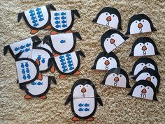 several penguins with numbers cut out on the floor