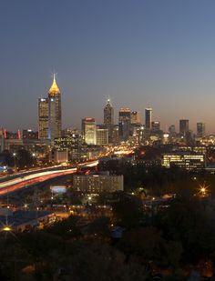 the city skyline is lit up at night