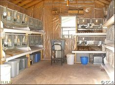 the inside of a building with many cages and buckets