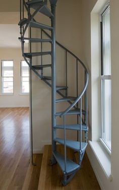 a metal spiral staircase in an empty room