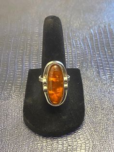 Approximately measures 1.1" x .6". Weighs 7.37 grams. Size 6.75. - Please note, most of my store's items are vintage or pre-owned. Most items are in very good/good vintage pre-owned condition. - Thank you so much for shopping with me and please check out my other jewelry listings, I post new items daily! Amber Cabochon Jewelry For Anniversary, Classic Amber Engraved Jewelry, Vintage Oval Filigree Ring As Gift, Classic Oval Cabochon Sterling Silver Jewelry, Oval Cabochon Filigree Jewelry For Anniversary, Vintage Adjustable Filigree Ring For Formal Occasions, Adjustable Vintage Filigree Ring For Formal Occasions, Antique Nickel-free Ring For Formal Occasions, Vintage Jewelry With Polished Finish For Memorials