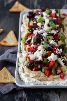 a platter filled with hummus and olives