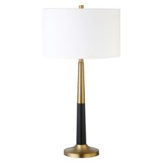 a black and gold table lamp with a white shade on the top, against a white background