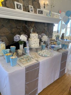 a table topped with lots of cakes and cupcakes