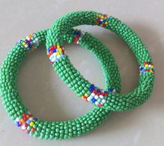 Beaded Bracelets | African Maasai Beaded Bracelets | African Jewelry | Beaded Bangles | Ethnic Bracelets| Gift For Her |A Set Of Two BanglesThese superbly crafted beaded bracelets are made of glass beads.The price is for a set of two bracelets.Main Color - Green.Available in different colors.Feel free to send me a convo or e-mail for any clarification.Thank you for visiting... Green Bangle Friendship Bracelets, Traditional Round Beads Bracelets For Beach, Traditional Round Bead Bracelets For The Beach, Traditional Beaded Bracelets For Beach, Traditional Tiny Beads Bracelet For Beach, Traditional Beaded Bracelets With Tiny Round Beads, Traditional Round Beads Bracelet For Beach, Traditional Green Beaded Bracelets As Gift, Traditional Beach Bracelet With Tiny Beads